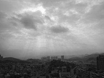 Cityscape against cloudy sky