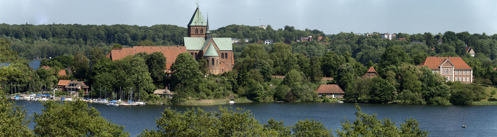 Panoramic view of lake and buildings against sky