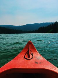 Close-up of boat in lake against sky