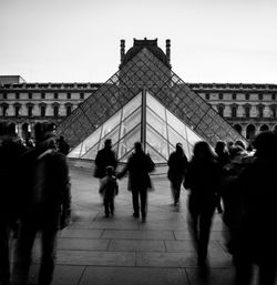 Group of people walking in front of building