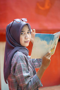 Cropped hand of woman using mobile phone