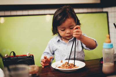 Portrait of boy sitting on table