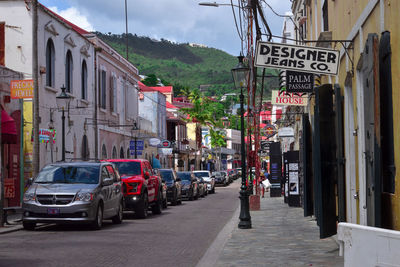 Cars on street against buildings in city