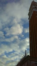 Low angle view of building against cloudy sky