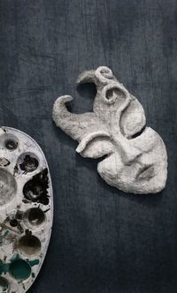 High angle view of carvings on table against black background