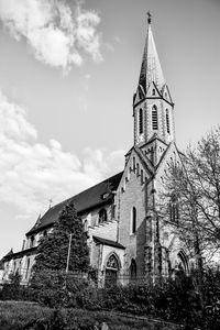 Low angle view of bell tower against sky