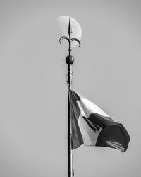 Low angle view of flag against clear sky