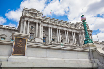 Low angle view of building against cloudy sky