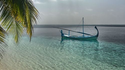 Fishing net in sea against sky