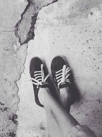 Low section of woman standing on sand