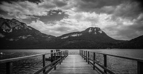 Pier over lake against mountains