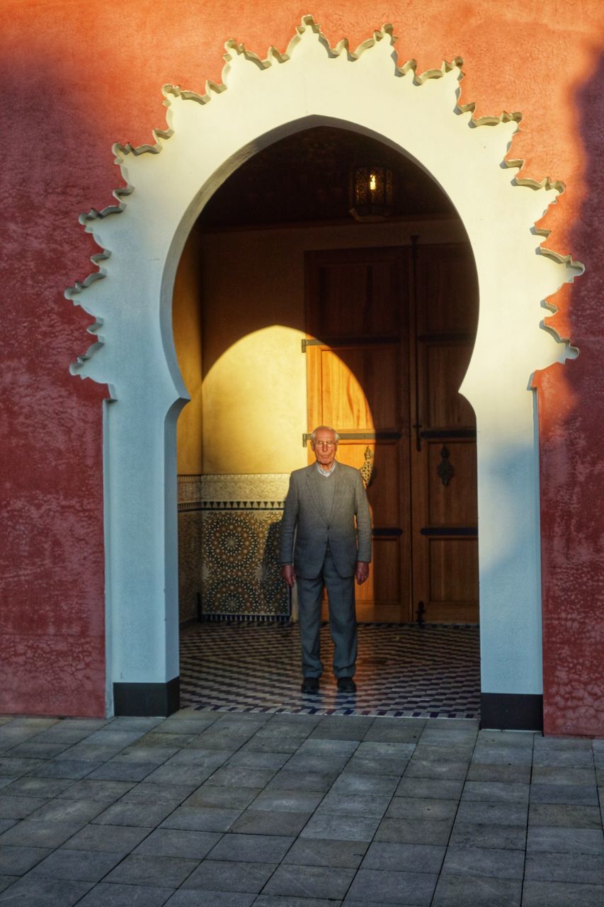 arch, architecture, full length, real people, built structure, rear view, two people, leisure activity, building exterior, standing, indoors, day, lifestyles, doorway, place of worship, men, togetherness, people