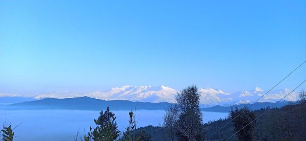 Scenic view of mountains against clear blue sky