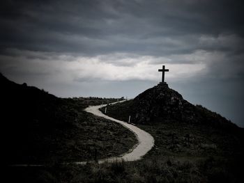 Scenic view of road leading towards mountains against sky
