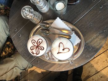 Directly above shot of coffee with froth art on table