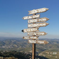 Information sign against sky