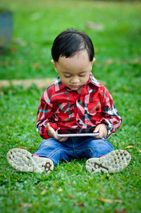 Boy sitting in grass