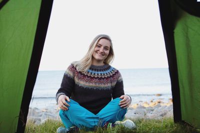 Portrait of young woman in tent opening