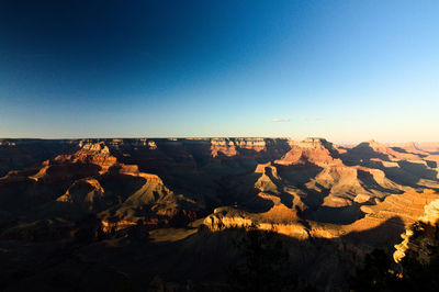 Scenic view of dramatic landscape against clear blue sky