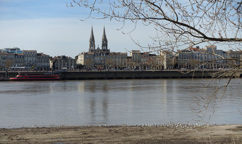 Bridge over river against buildings in city