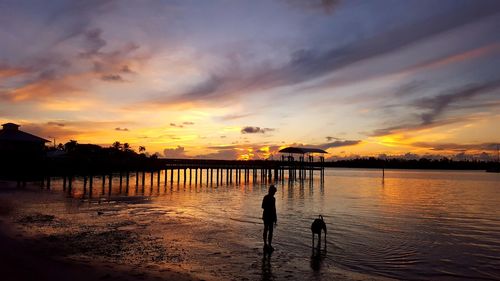 Scenic view of lake against orange sky