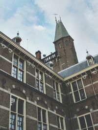 Low angle view of historical building against cloudy sky