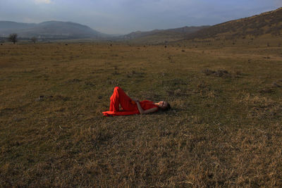 Woman sleeping on field