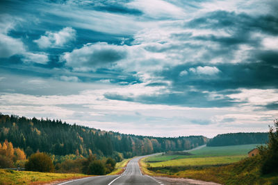 Empty road along countryside landscape