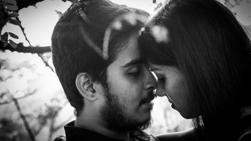 Close-up of young couple romancing at park