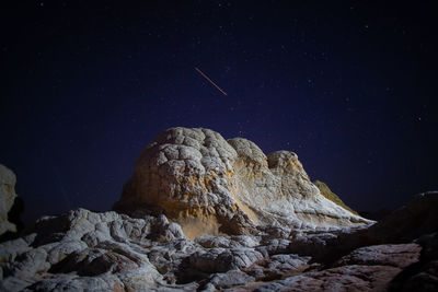 Low angle view of rock formation against sky