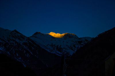 Scenic view of mountains against clear blue sky