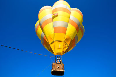 Low angle view of hot air balloon against blue sky