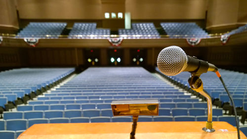 Close-up of microphone in conference hall