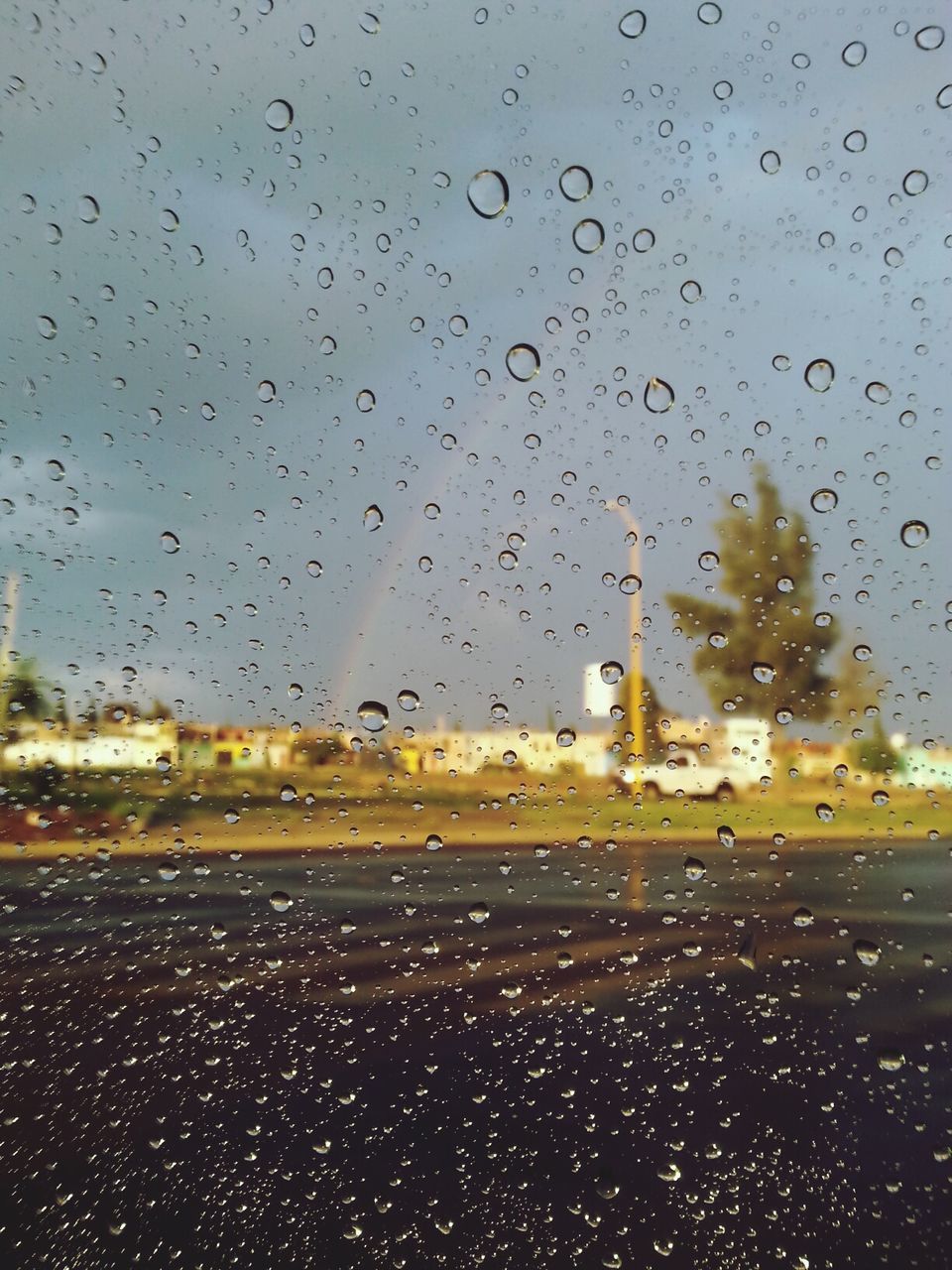 wet, drop, rain, window, transportation, transparent, weather, glass - material, car, mode of transport, sky, raindrop, season, water, land vehicle, indoors, road, vehicle interior, building exterior, windshield