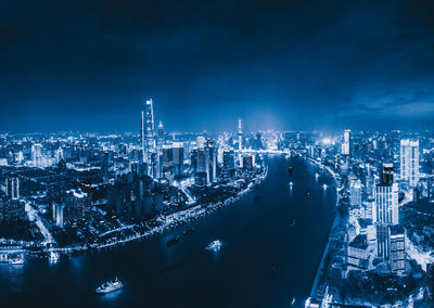 High angle view of illuminated city buildings against sky