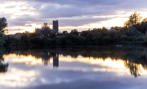 Reflection of trees in lake against sky during sunset