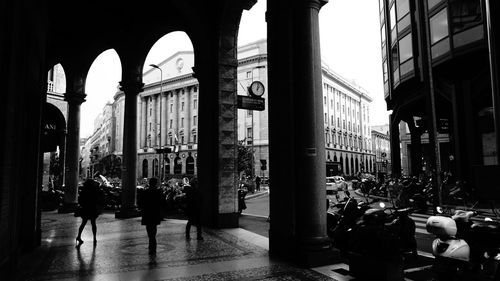 City street and buildings seen through colonnade