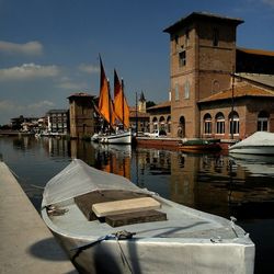 Boats in river with buildings in background