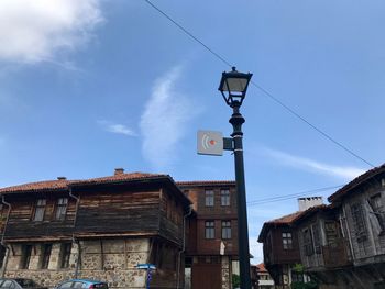 Low angle view of street and buildings against sky