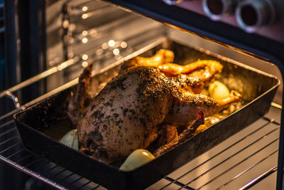 Close-up of roasted chicken on barbecue grill