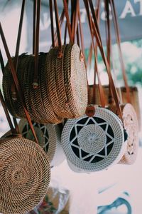 Close-up of wicker bags hanging for sale at market