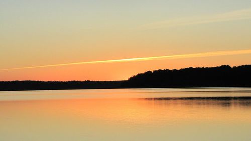 Scenic view of lake at sunset