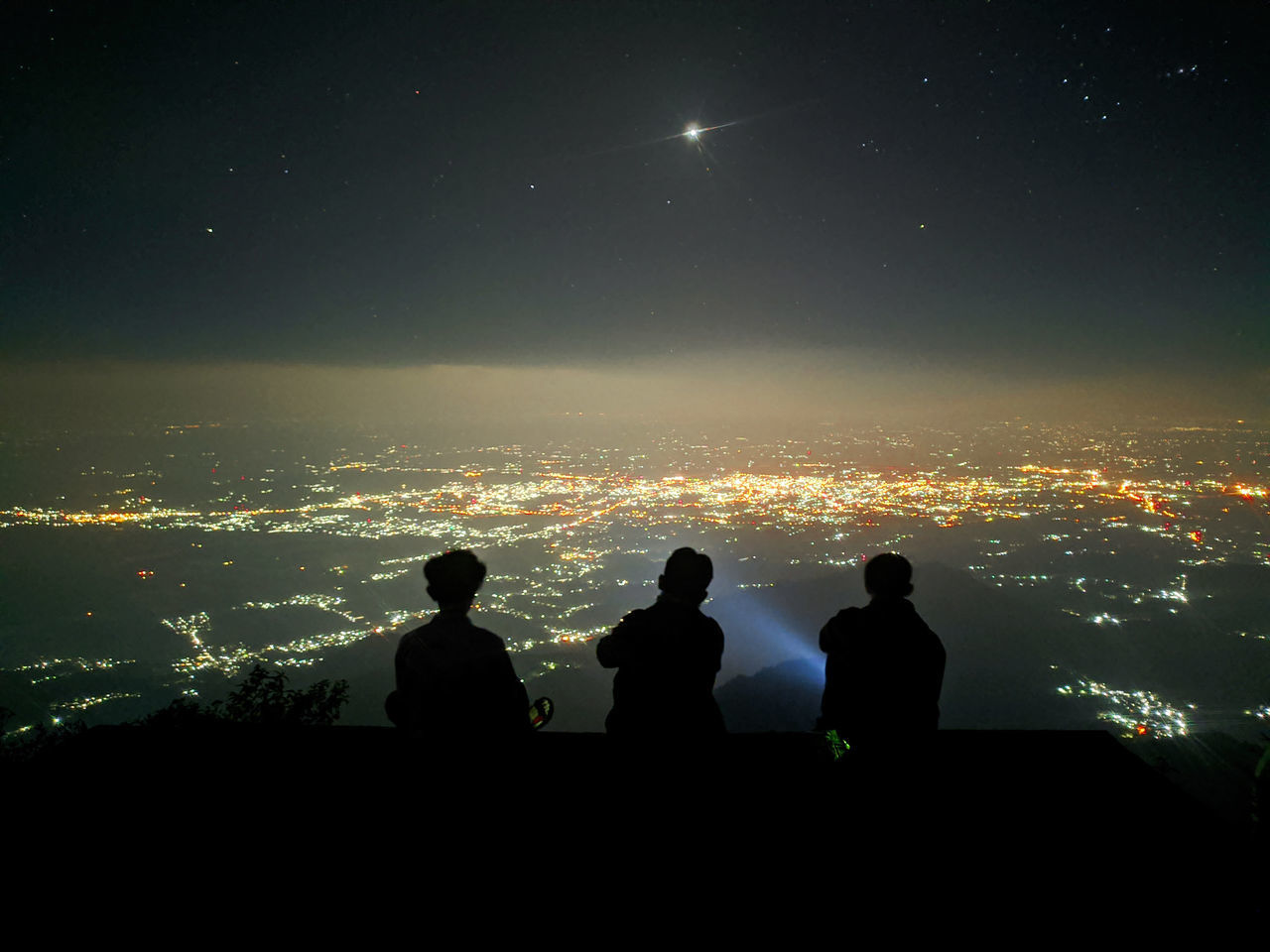 SILHOUETTE PEOPLE SITTING AGAINST SKY DURING NIGHT