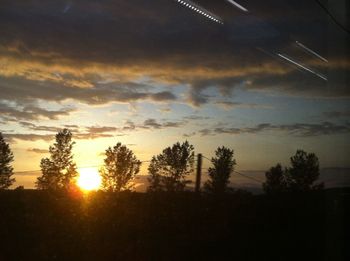 Scenic view of landscape against sky at sunset