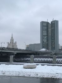 View of skyscrapers against cloudy sky