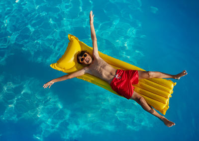 Low section of woman swimming in pool