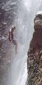 Person standing on rock in water