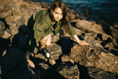 High angle view of woman on rocks at shore