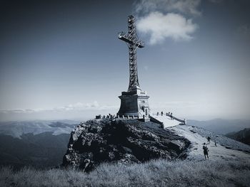 Heroes cross on caraiman peak against sky