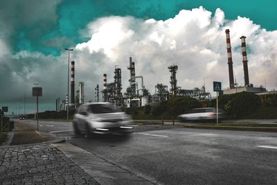 Factory against cloudy sky